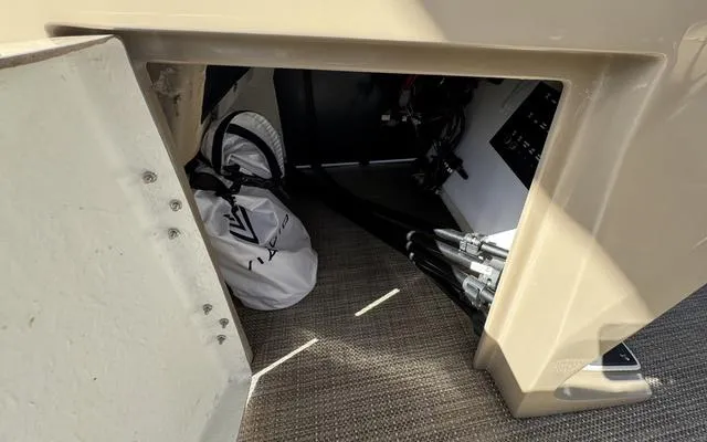 Slide: The Image of Storage compartment in 2025 Viaggio Lago X 22 U boat, featuring equipment and wiring. - 25