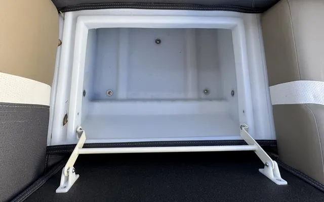 Slide: The Image of Viaggio Lago X 22 U 2025 storage compartment, open and empty, with beige and white seating. - 34