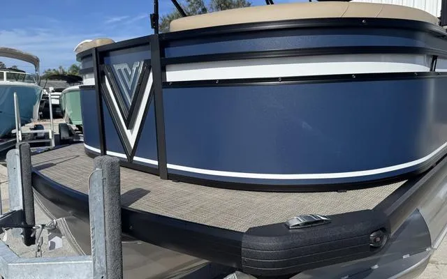 Slide: The Image of 2025 Viaggio Lago X 22 U pontoon boat, blue exterior, on a trailer. - 4