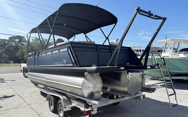 Slide: The Image of 2025 Viaggio Lago X 22 U pontoon boat on trailer, featuring sleek design and canopy. - 7