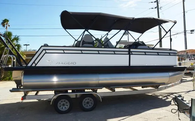 Slide: The Image of 2025 Viaggio Lago X 22 Q pontoon boat on trailer, black canopy, sleek design. - 12