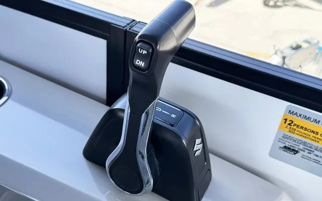 Slide: The Image of Throttle control lever on 2025 Viaggio LAgo X 22 Q boat dashboard. - 26