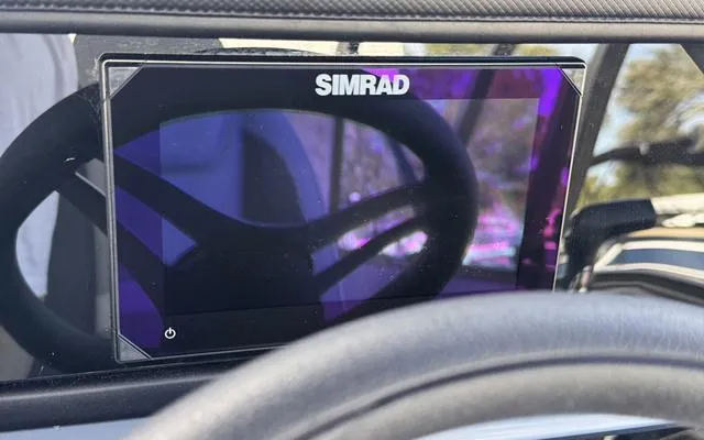 Slide: The Image of Simrad display on 2025 Viaggio LAgo X 22 Q dashboard, steering wheel reflection visible. - 28