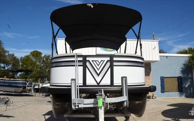 Slide: The Image of 2025 Viaggio LAgo X 22 Q pontoon boat with canopy, parked outdoors. - 3