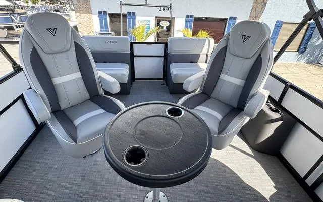 Slide: The Image of 2025 Viaggio Lago X 22 Q boat interior with gray seating and round table. - 30