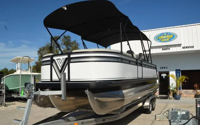 Slide: The Image of 2025 Viaggio LAgo X 22 Q pontoon boat on trailer, dealership background. - 4
