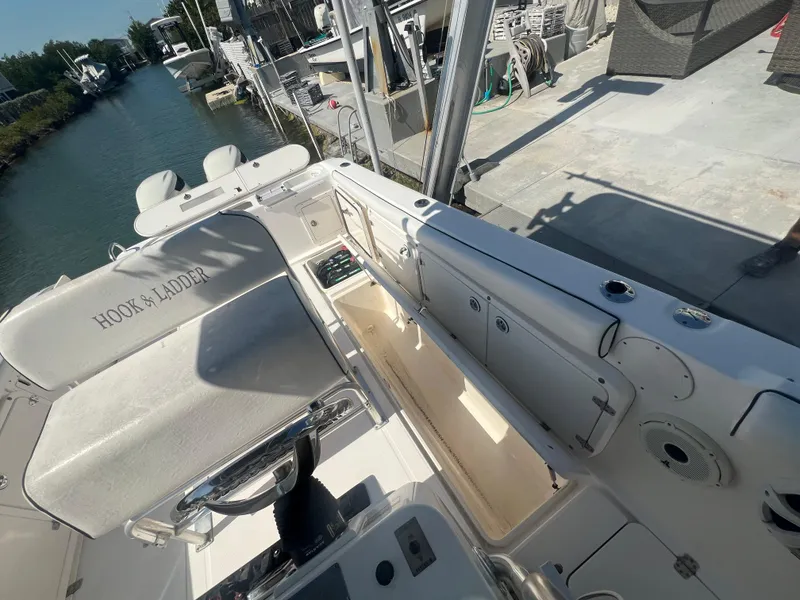 Slide: The Image of 2004 Century 2900 Center Console boat interior with open storage, docked by a canal. - 10