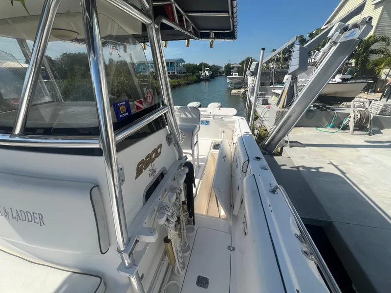 Slide: The Image of 2004 Century 2900 Center Console boat docked by a canal. - 11