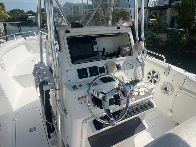 Slide: The Image of 2004 Century 2900 Center Console boat interior with steering wheel and navigation equipment. - 3