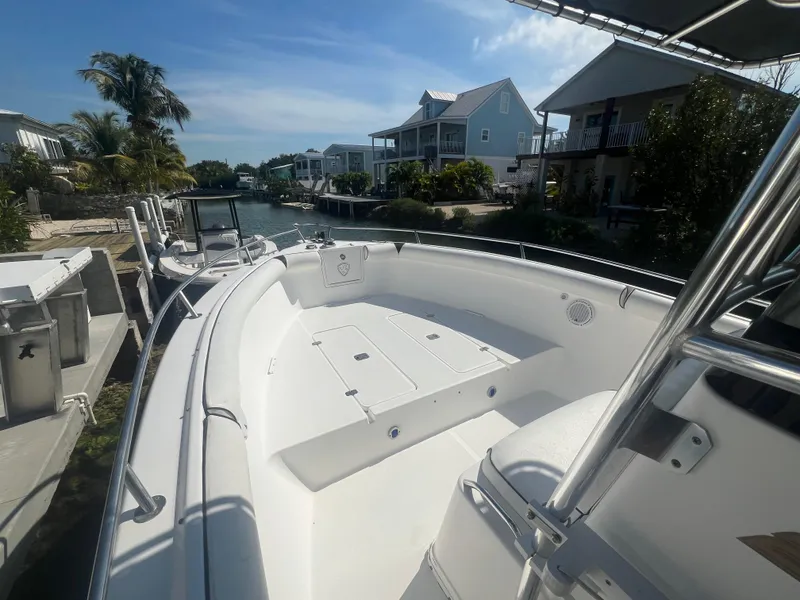 Slide: The Image of 2004 Century 2900 Center Console boat docked near waterfront homes. - 6