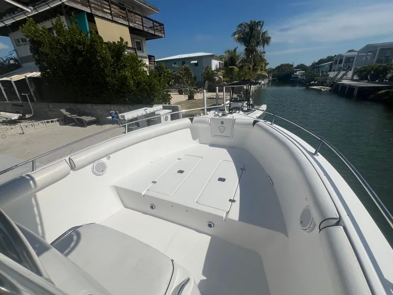 Slide: The Image of 2004 Century 2900 Center Console boat docked by a canal, surrounded by tropical scenery. - 7