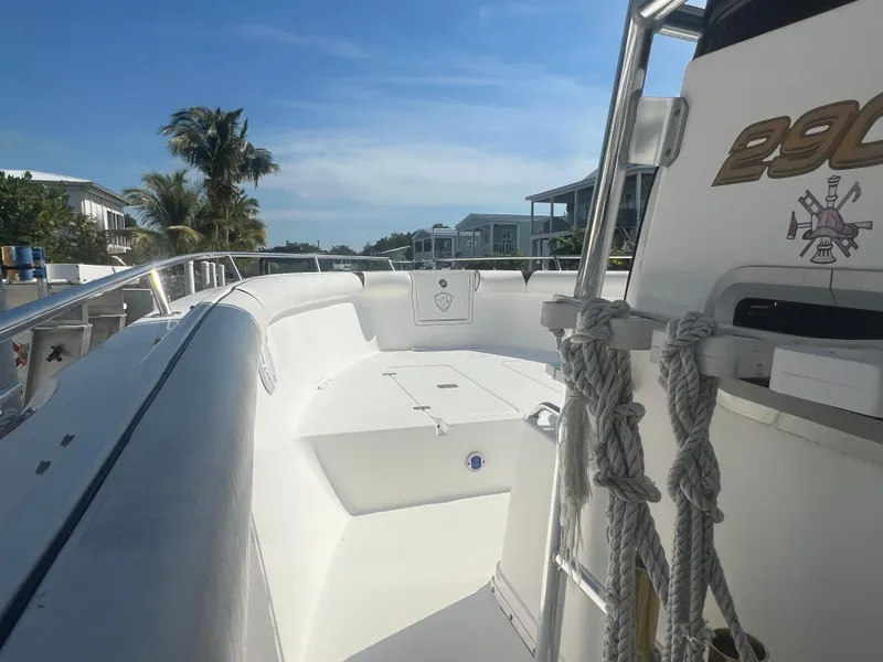 Slide: The Image of 2004 Century 2900 Center Console boat with spacious deck, docked near palm trees and waterfront homes. - 8