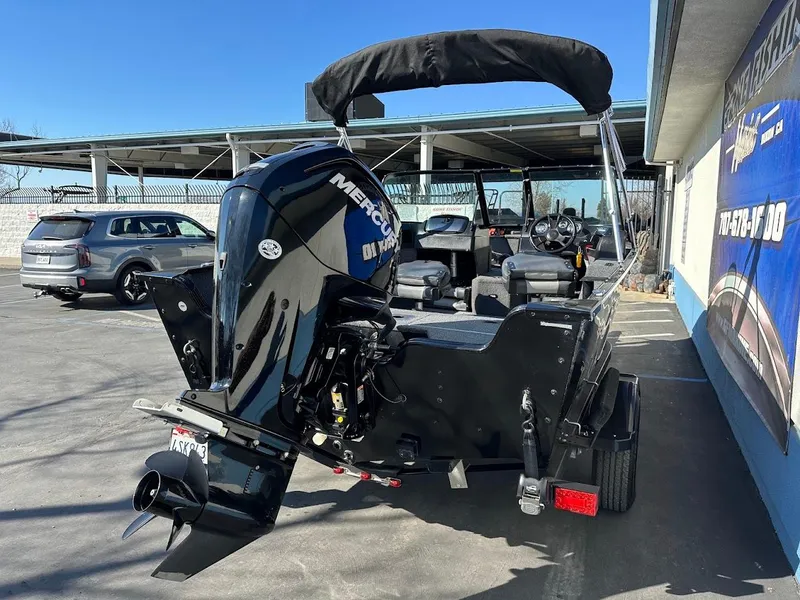 Slide: The Image of 2019 Lowe FM 165 Pro WT boat with Mercury outboard motor in parking lot. - 11