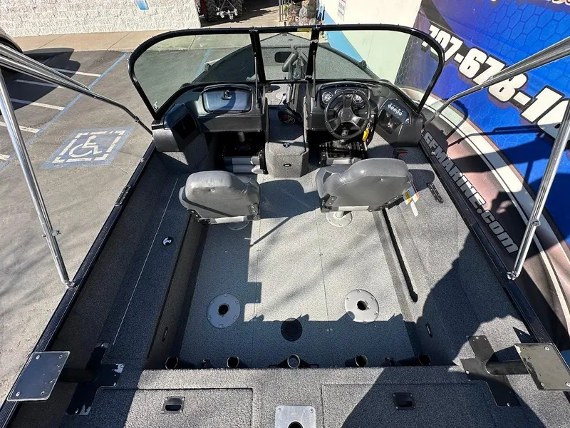 Slide: The Image of 2019 Lowe FM 165 Pro WT boat interior with steering console and seating. - 13