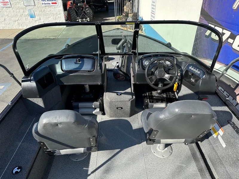 Slide: The Image of 2019 Lowe FM 165 Pro WT boat interior with dual seats and steering console. - 14