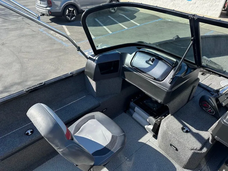 Slide: The Image of 2019 Lowe FM 165 Pro WT boat interior with seating and dashboard. - 15