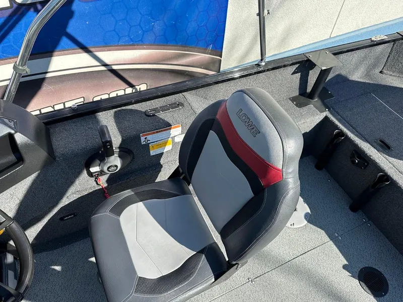 Slide: The Image of 2019 Lowe FM 165 Pro WT boat interior with gray and red seating. - 17