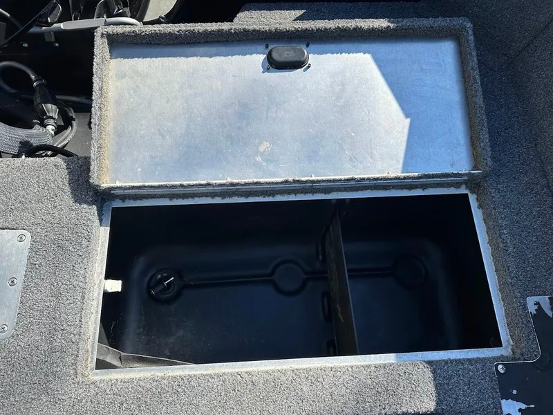 Slide: The Image of Open storage compartment in a 2019 Lowe FM 165 Pro WT boat. - 21