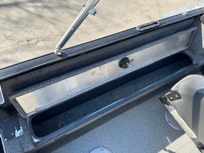 Slide: The Image of 2019 Lowe FM 165 Pro WT boat interior storage compartment, open and empty. - 22