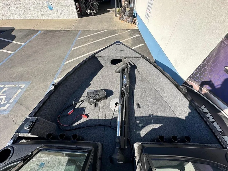 Slide: The Image of 2019 Lowe FM 165 Pro WT boat interior, featuring spacious deck and fishing equipment. - 24