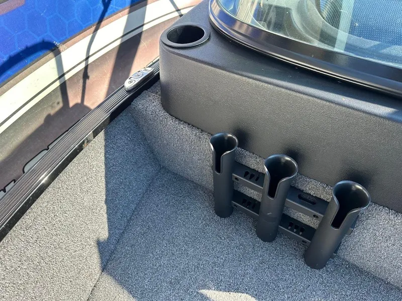 Slide: The Image of 2019 Lowe FM 165 Pro WT boat interior with rod holders and cup holder. - 26