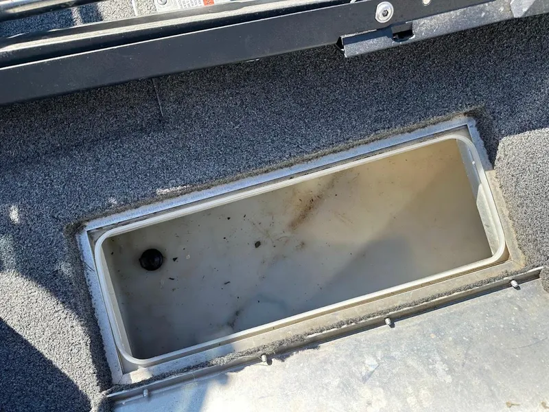 Slide: The Image of 2019 Lowe FM 165 Pro WT boat storage compartment, open and empty. - 28