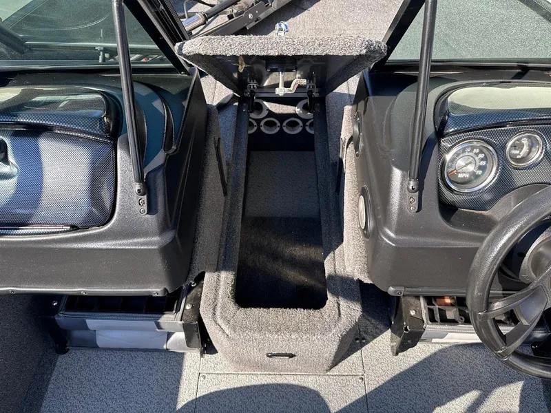 Slide: The Image of 2019 Lowe FM 165 Pro WT boat interior with dashboard and storage compartment. - 30