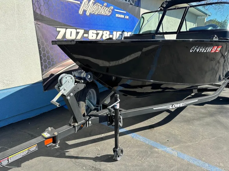Slide: The Image of 2019 Lowe FM 165 Pro WT boat on trailer, parked outdoors. - 6
