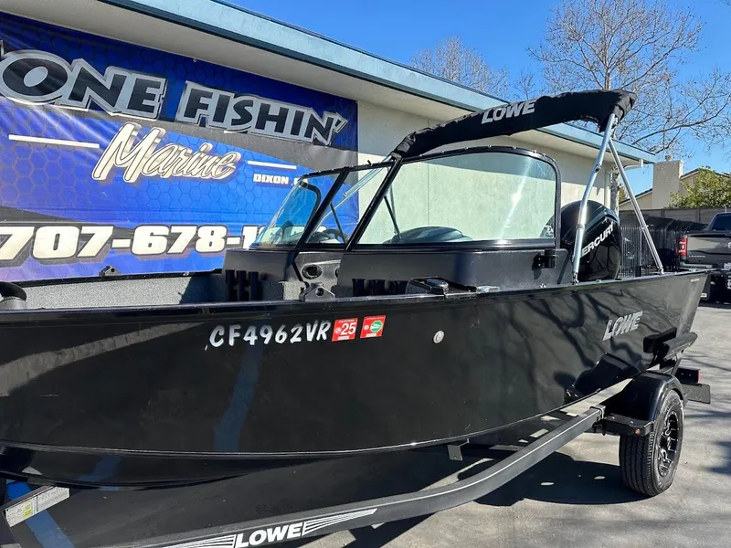 Slide: The Image of 2019 Lowe FM 165 Pro WT boat in black, parked at a marine dealership. - 7