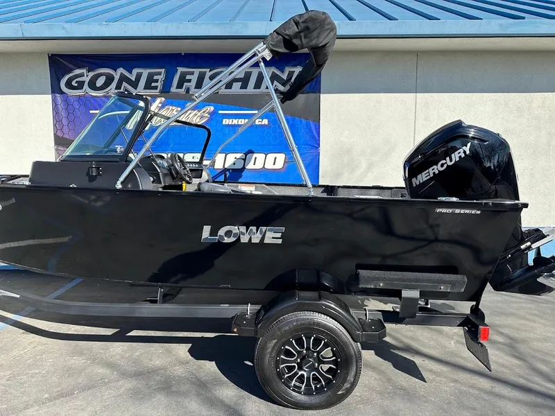 Slide: The Image of 2019 Lowe FM 165 Pro WT boat with Mercury engine, displayed outdoors. - 8