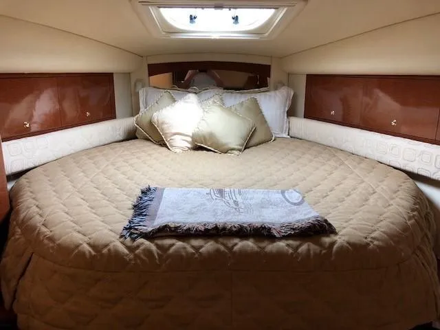 Slide: The Image of Luxurious cabin interior of 2003 Sea Ray 340 Sundancer with plush bedding. - 10
