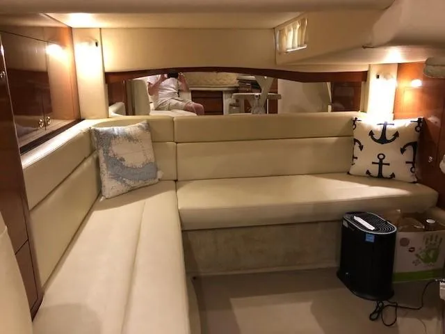 Slide: The Image of Interior of 2003 Sea Ray 340 Sundancer with beige seating and nautical decor. - 11