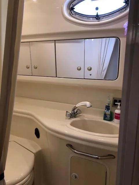 Slide: The Image of Bathroom interior of 2003 Sea Ray 340 Sundancer yacht, featuring sink and storage cabinets. - 15