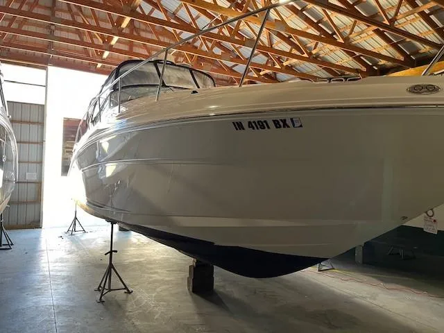 Slide: The Image of 2003 Sea Ray 340 Sundancer boat stored indoors on stands. - 17
