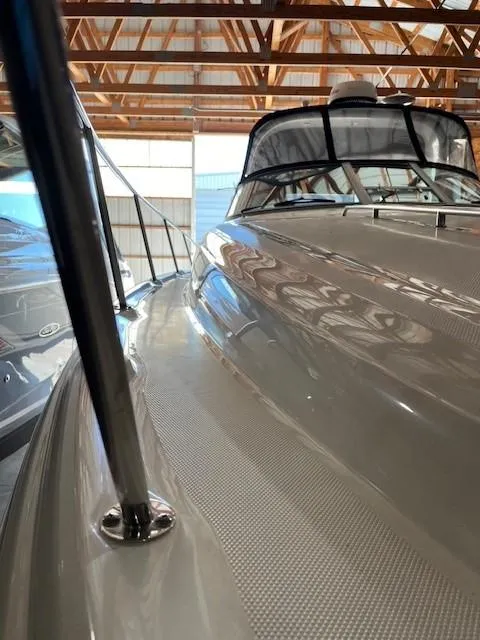 Slide: The Image of 2003 Sea Ray 340 Sundancer in storage, showcasing sleek design and craftsmanship. - 18