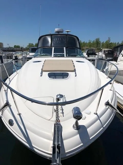 Slide: The Image of 2003 Sea Ray 340 Sundancer yacht docked at marina under clear blue sky. - 2