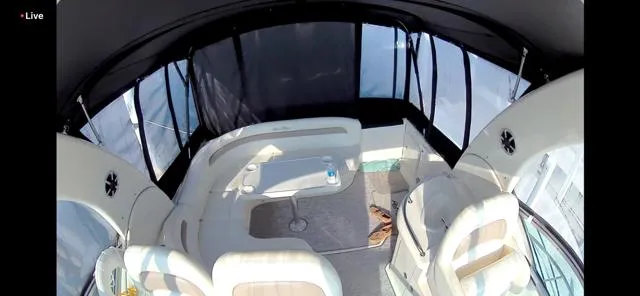 Slide: The Image of 2003 Sea Ray 340 Sundancer interior with seating and table, enclosed by windows. - 4