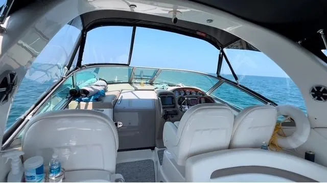 Slide: The Image of 2003 Sea Ray 340 Sundancer cockpit with ocean view, featuring white seating and control panel. - 8