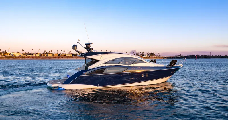 Slide: The Image of 2009 Marquis 420 Sport Coupe yacht cruising on serene waters at sunset. - 1