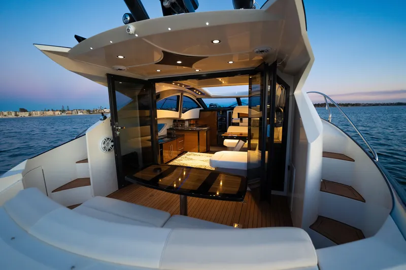 Slide: The Image of Luxurious 2009 Marquis 420 Sport Coupe yacht interior with elegant seating and scenic ocean view. - 10