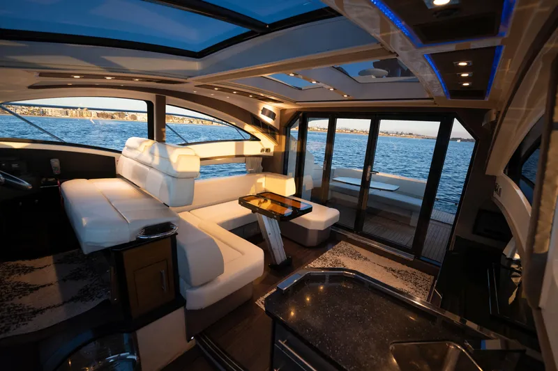 Slide: The Image of Luxurious interior of 2009 Marquis 420 Sport Coupe yacht with panoramic windows and elegant seating. - 15
