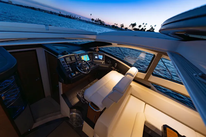 Slide: The Image of Interior of 2009 Marquis 420 Sport Coupe yacht at sunset, featuring modern navigation equipment. - 18