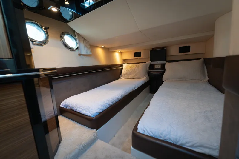 Slide: The Image of Interior of 2009 Marquis 420 Sport Coupe yacht with twin beds and porthole windows. - 22