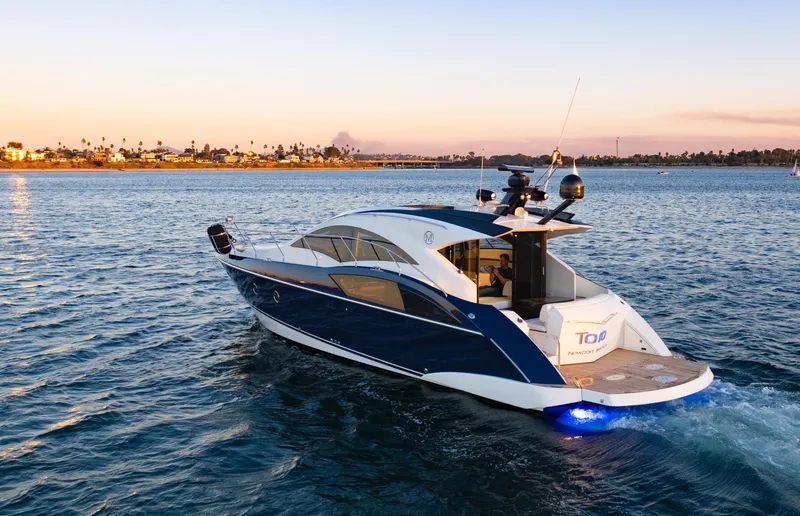Slide: The Image of 2009 Marquis 420 Sport Coupe yacht cruising at sunset on open water. - 3