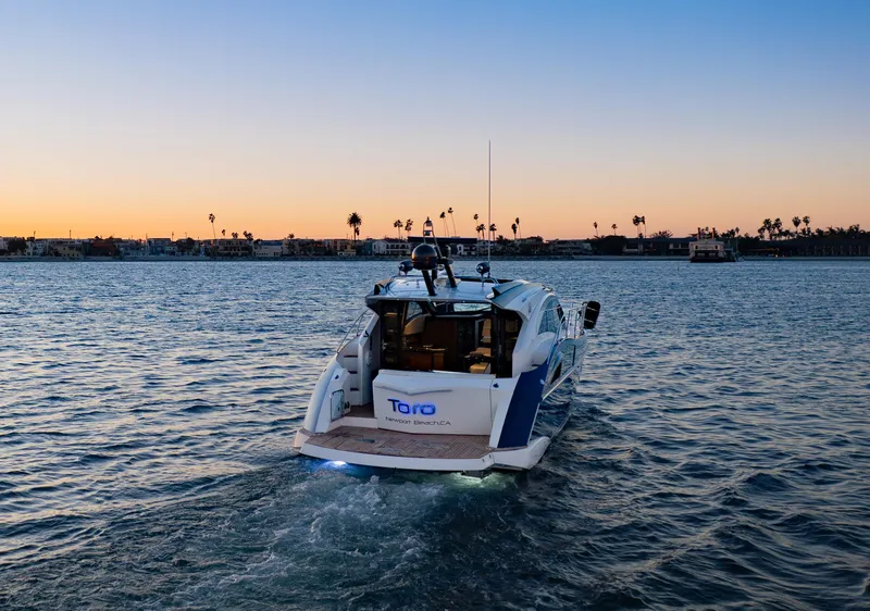 Slide: The Image of 2009 Marquis 420 Sport Coupe yacht cruising at sunset on open water. - 7