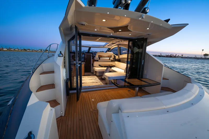Slide: The Image of Luxurious 2009 Marquis 420 Sport Coupe yacht interior with elegant seating and scenic ocean view. - 8
