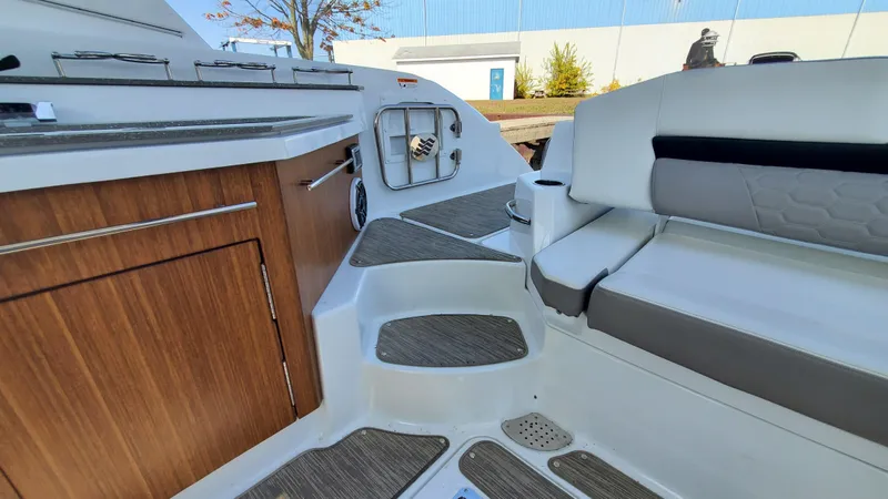 Slide: The Image of Interior of 2021 Four Winns H350 boat with seating and wooden cabinetry. - 27