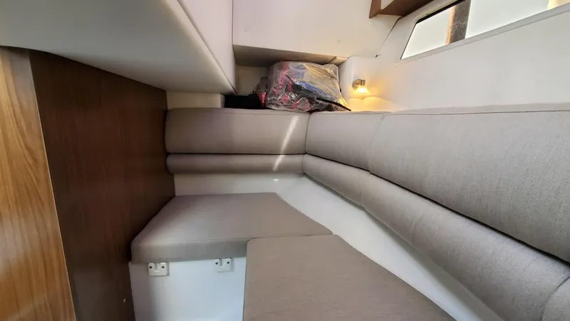Slide: The Image of 2021 Four Winns H350 cabin interior with cushioned seating and ambient lighting. - 34