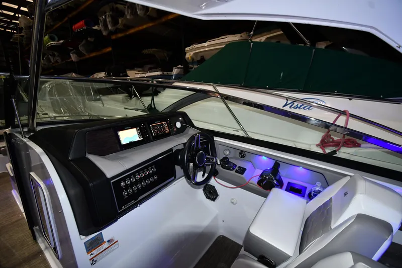 Slide: The Image of Interior view of 2021 Four Winns H350 boat cockpit with modern controls and seating. - 49