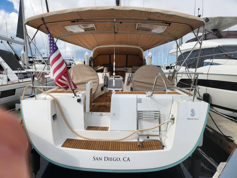Slide: The Image of 2012 Beneteau Oceanis 50 sailboat docked in San Diego marina, featuring a spacious deck. - 12